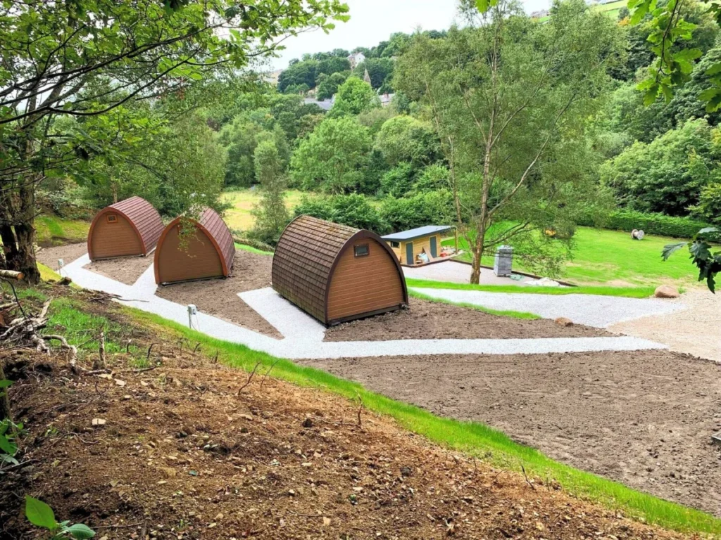 Gravel paths winding between the glamping pods on the hillside